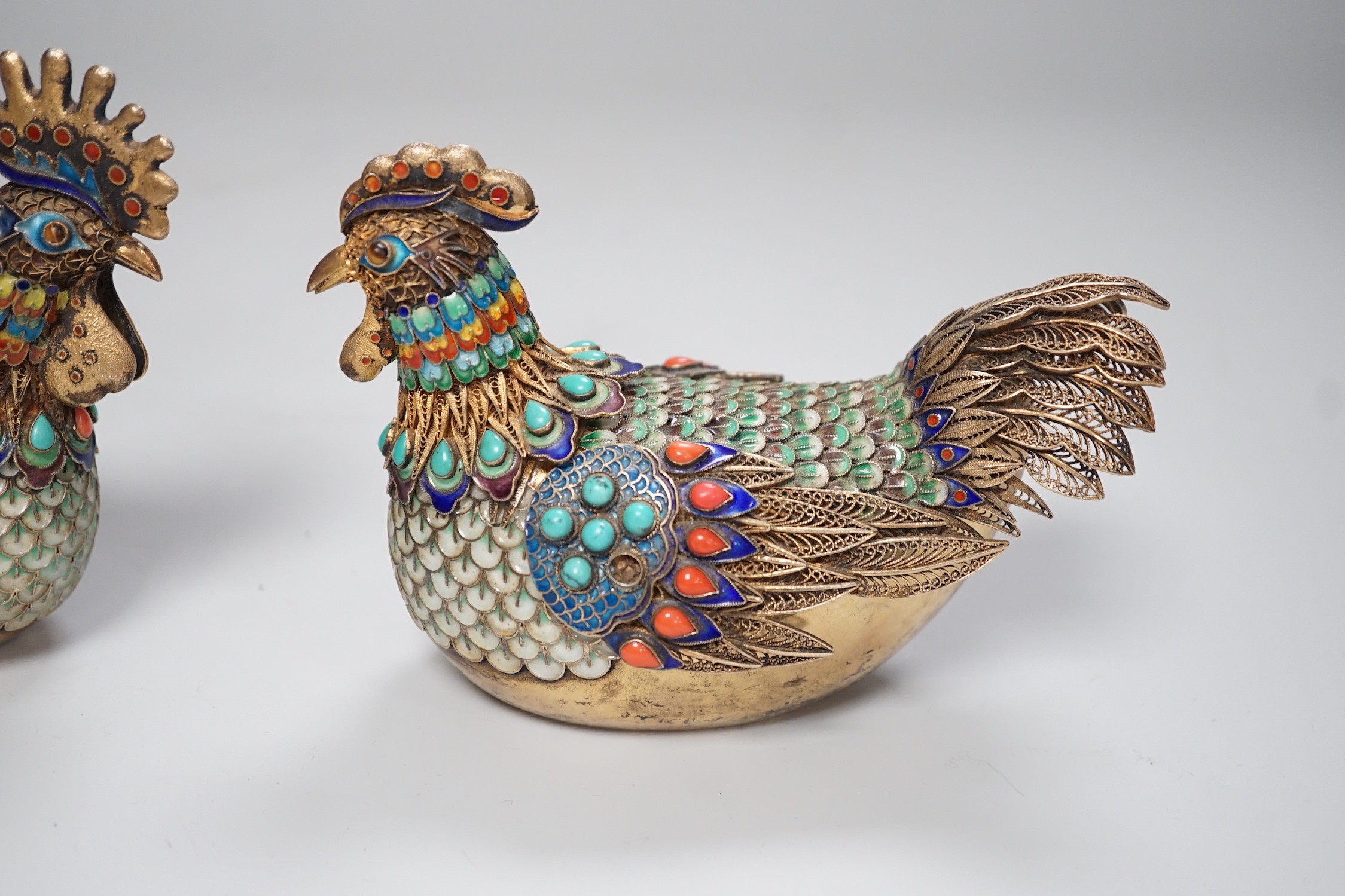 A pair of cased Chinese enamelled gilt white metal roosters with turquoise and coral mounts 14cms wide